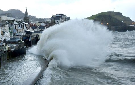Wave slams coast during a storm surge event.