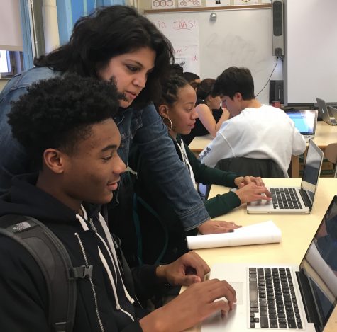 Ms. Charter helps Nathaniel Harpaz on his project during module.