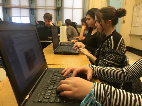 Students using computers in iNews module.