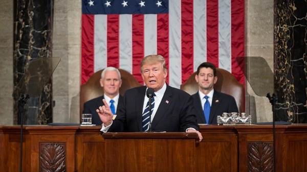 Trump giving a speech to Congress; Mike Pence and Paul Ryan are behind him.