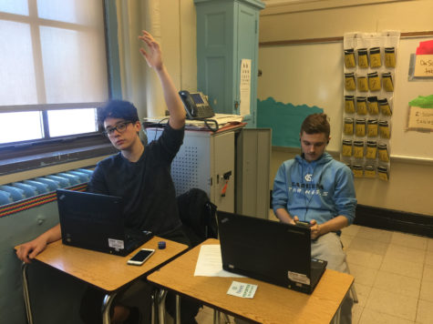 Photograph obtained from iSchool. Cade Smith left, and Kamil Kuzminski are in class doing work.