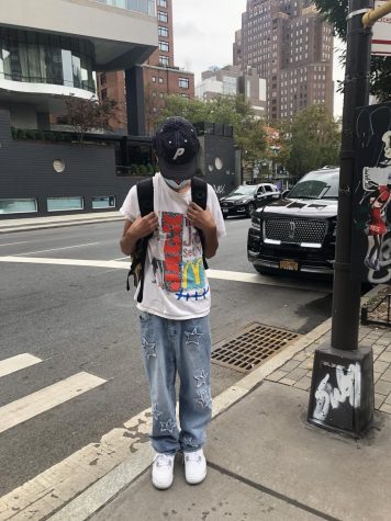 Luca Tejada, a junior at the iSchool, in star jeans, a graphic T-shirt and a baseball cap