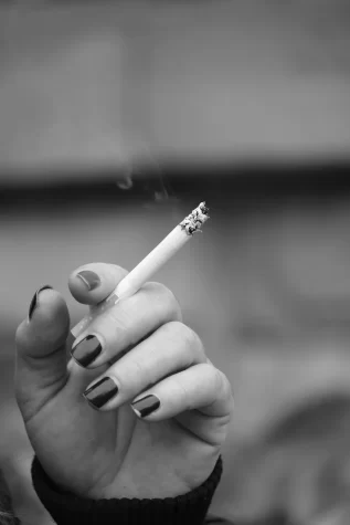 A hand holding a cigarette