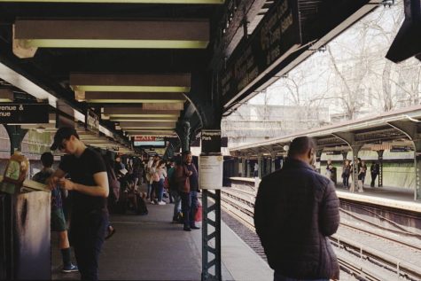 People standing in subway station. 