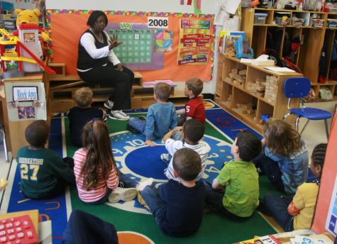 Young students in classroom with teacher. 